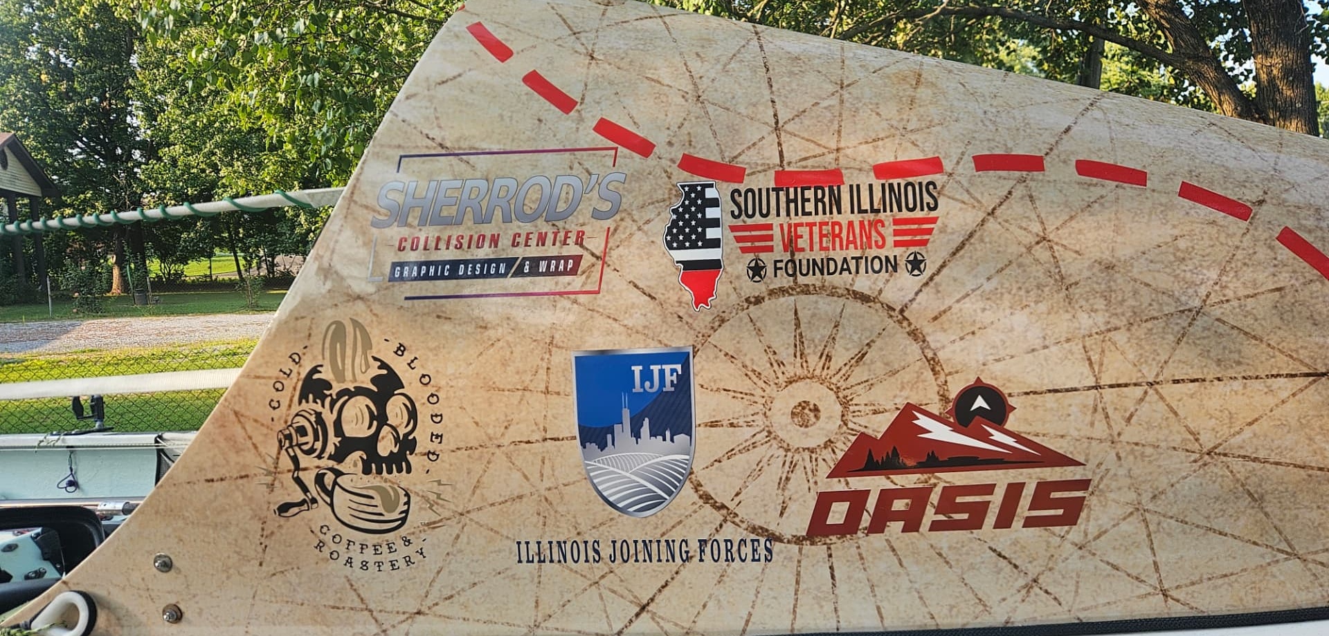 Sponsor logos on the Oarsome Odyssey boat hull